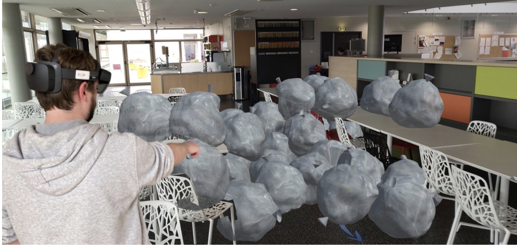 A user looks at the amount of waste produced by his corporate restaurant in a week. The waste is represented by virtual trash bags which are displayed directly in the restaurant using augmented reality
